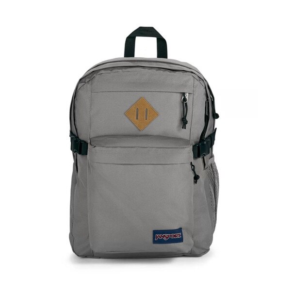 A gray jansport backpack with two front pockets and two main compartments, with side mesh pockets, shoulder straps, and a top strap to hold.